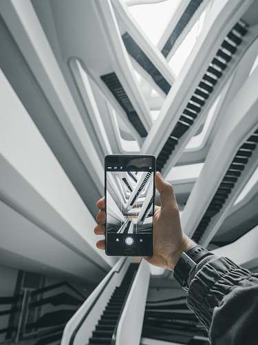 leisure activities person taking a photo of escalators in building music